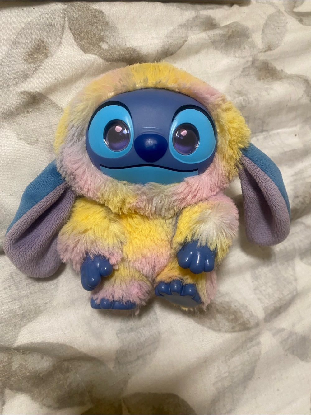Blue-Faced Plush Character in Pastel Yellow-Pink Fur